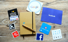 Social media icons near a notebook
