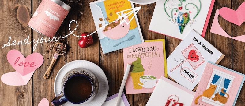greeting cards and tea on wooden table