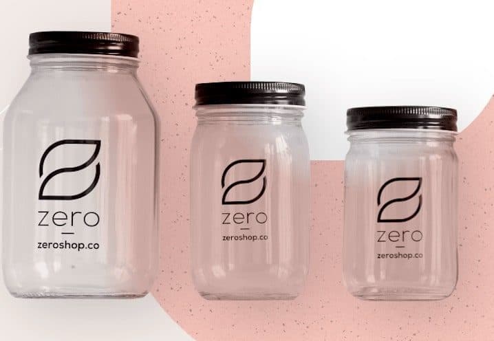 Three glass jars with pink and white background